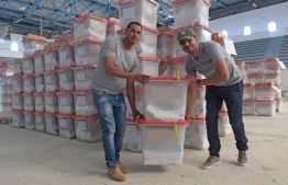 Workers of Tunisia's Independent High Authority for Elections (ISIE) dispatch ballot boxes to polling stations in Tunis on October 5, 2019, ahead of tomorrow's legislative elections. - Just weeks after Tunisians rejected ruling political parties in the first round of presidential polls, voters are set to return to the ballot box on October 6 to elect a new parliament. (Photo by FETHI BELAID / AFP)
