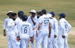 Indian cricketer Ravindra Jadeja (L) celebrates with teammates after the dismissal of South African cricketer Vernon Philander during the fifth day's play of the first Test match between India and South Africa at the Dr. Y.S. Rajasekhara Reddy ACA-VDCA Cricket Stadium in Visakhapatnam on October 6, 2019. - India's spin king Ravichandran Ashwin on October 6 joined Sri Lankan great Muttiah Muralitharan as the fastest bowler to 350 Test wickets in the first match against South Africa in Visakhapatnam. (Photo by NOAH SEELAM / AFP) / 