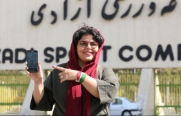 Iranian sports journalist Raha Pourbakhsh shows purchased electronic tickets for the Iran - Cambodia World Cup 2022 qualifier match during an interview with AFP in front of Azadi stadium in the capital Tehran on October 8, 2019. - After a ban spanning decades, Iranian women are set to freely enter a football stadium for the first time on October 10 as Iran hosts Cambodia in a World Cup 2022 qualifier at Tehran's Azadi stadium. (Photo by ATTA KENARE / AFP)
