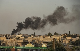 Smoke billows following Turkish bombardment on Syria's northeastern town of Ras al-Ain in the Hasakeh province along the Turkish border on October 9, 2019. - Turkey launched an assault on Kurdish forces in northern Syria with air strikes and explosions reported along the border. President Recep Tayyip Erdogan announced the start of the attack on Twitter, labelling it "Operation Peace Spring". (Photo by Delil SOULEIMAN / AFP)