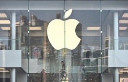 A man walks inside the Apple store in Hong Kong on October 10, 2019. Apple, along with Google pulled Fortnite from their mobile app shops after its maker Epic Games released an update that dodges revenue sharing. (Photo by Philip FONG / AFP)
