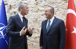 This handout picture taken and released on October 11, 2019 by the Turkish Foreign Ministry press office shows Turkey's Minister of Foreign Affairs Mevlut Cavusoglu (R) speaking with NATO Secretary General Jens Stoltenberg, as they pose for photographs prior to their meeting at Dolmabahce Palace in Istanbul. (Photo by Cem Ozdel / Turkish Foreign Ministry Press Office / AFP) / RESTRICTED TO EDITORIAL USE - MANDATORY CREDIT "AFP PHOTO / CEM OZDEL / TURKISH FOREIGN MINISTRY PRESS OFFICE" - NO MARKETING NO ADVERTISING CAMPAIGNS - DISTRIBUTED AS A SERVICE TO CLIENTS
