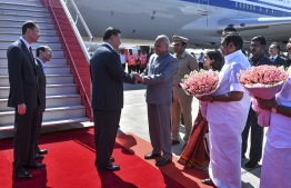 In this handout photograph taken and released by Indian Ministry of External Affairs (MEA) on October 11, 2019, China's President Xi Jinping (3L) arrives in Chennai, to attend a summit with India's Prime Minister Narendra Modi at the World Heritage Site of Mahabalipuram from October 11 to 12 in Tamil Nadu state. (Photo by Handout / Indian Ministry of External Affairs (MEA) / AFP) / 