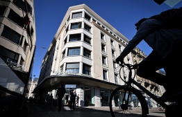 A picture taken on October 11, 2019, shows a cyclist passing by the building hosting Facebook's Libra Networks LLC company downtown Geneva, as Paypal announced they will withdraw from the Libra network. - Libra is a permissioned blockchain digital currency proposed by the American social media company Facebook. The project, currency and transactions are to be managed and cryptographically entrusted to the Libra Association, a membership organization founded by Facebook's subsidiary Calibra and 27 others across payment, technology, telecommunication, online marketplace, venture capital and nonprofits. (Photo by Fabrice COFFRINI / AFP)