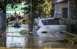 Flooded vehicles are seen in the aftermath of Typhoon Hagibis in Kawasaki on October 13, 2019. - Japan's military scrambled October 13 to rescue people trapped by flooding in the aftermath of powerful Typhoon Hagibis, which killed at least four people, caused landslides and burst rivers. (Photo by Odd ANDERSEN / AFP)
