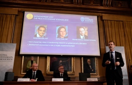 Peter Fredriksson (L), chairman of the Economic Sciences Prize Committee 2019, and the Royal Swedish Academy of Sciences' secretary general Goran Hansson (2nd L) listen to Jakob Svensson (R), member of the Economic Sciences Prize Committee 2019, as he explains the field of work of the co-winners of the 2019 Sveriges Riksbank Prize in Economic Sciences in Memory of Alfred Nobel (on the screen, L-R: Abhijit Banerjee, Esther Duflo and Michael Kremer) during a press conference at the Royal Swedish Academy of Sciences in Stockholm, Sweden, on October 14, 2019. Indian-born Abhijit Banerjee of the US, French-American Esther Duflo and Michael Kremer of the US won the Nobel Economics Prize for their "experimental approach to alleviating global poverty", the Royal Swedish Academy of Sciences said.
Jonathan NACKSTRAND / AFP