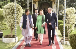 Pakistan's Prime Minister Imran Khan (L) walks with Britain's Prince William (R), Duke of Cambridge, and his wife Catherine (C), Duchess of Cambridge, at the Prime Minister House in Islamabad on October 15, 2019. - Pakistani Prime Minister Imran Khan gave a warm welcome in Islamabad on October 15 to Britain's Prince William, the son of his late friend Princess Diana, who is on his first official trip to the country with his wife Kate. (Photo by STR / AFP)