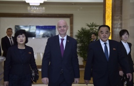 FIFA President Gianni Infantino (C) arrives at Pyongyang international airport in Pyongyang on October 15, 2019. - Infantino is scheduled to attend the match between North Korea and South Korea during the second round of the 2022 FIFA World Cup Asian Zone qualifiers at Kim Il Sung Stadium on October 15 and will visit the Pyongyang International Football School. (Photo by Kim Won-Jin / AFP)