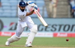 India's captain Virat Kohli plays a shot on the second day of the second Test cricket match between India and South Africa at the Maharashtra Cricket Association Stadium in Pune on October 11, 2019. PHOTO: PUNIT PARANJPE / AFP