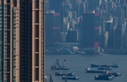 (FILES) In this file photo taken on August 20, 2019 Barges and cargo ships are seen in the waters of Hong Kong's Victoria Harbour on August 20, 2019. - Shipowners say they are trying to cut their heavy-polluting industry's impact on the environment by using cleaner energy -- but some have stalled over limiting the speed of ships. (Photo by Philip FONG / AFP)