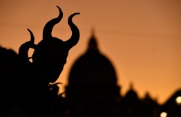 (FILES) In this file photo taken on October 7, 2019 A dressed up fan waits for the arrival of talents for the European premiere of Disney's dark fantasy adventure film "Maleficent : Mistress of Evil" in Rome. - Disney's new "Maleficent: Mistress of Evil" topped the North American box office for the weekend with an estimated take of USD 36 million despite falling far below the original 2014 film, an industry group reported on October 20, 2019. (Photo by Tiziana FABI / AFP)