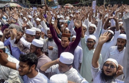 Islamist activists shout slogans as they take part in a protest in Dhaka on October 21, 2019, a day after deadly clashes when police shot at Bangladeshi Muslims protesting Facebook messages that allegedly defamed the Prophet Mohammed. - Bangladesh police on October 21 was investigating up to 5,000 people for taking part in one of the nation's deadliest religious riots where at least four were killed when officers fired on protesters. (Photo by Munir UZ ZAMAN / AFP)
