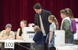 Leader of the Liberal Party of Canada, Justin Trudeau votes with his family in Montreal, Quebec on  October 21, 2019. - Canadians began voting in a general election Monday, with surveys predicting a minority government as Prime Minister Justin Trudeau's Liberal Party risks losing its majority or even being kicked out of office.The Liberals and the Conservatives, led by Andrew Scheer, could be set for a near dead heat with pundits calling it one Canada's closest elections ever. (Photo by Sebastien ST-JEAN / AFP)