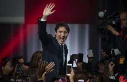 Prime minister Justin Trudeau celebrates his victory with his supporters at the Palais des Congres in Montreal during Team Justin Trudeau 2019 election night event in Montreal, Canada on October 21, 2019. - Prime Minister Justin Trudeau's Liberal Party held onto power in a nail-biter of a Canadian general election on Monday, but as a weakened minority government.
Television projections declared the Liberals winners or leading in 157 of the nation's 338 electoral districts, versus 121 for his main rival Andrew Scheer and the Conservatives, after polling stations across six time zones closed. (Photo by Sebastien ST-JEAN / AFP)
