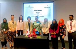 Ambassador of Japan to Maldives Keiko Yanai (L-4), \ Fiyavathi's CEO Zeena Gasim (R-4) and Minister of State for Gender, Family and Social Services Aishath Rasheed (C) at the ceremony where the Japanese government signed a grant of USD 48,500 to provide a minibus to 'Fiyavathi'. PHOTO/EMBASSY OF JAPAN
