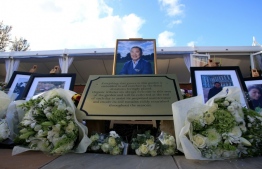 Floral tributes and photographs placed at the Vichai Srivaddhanapraba Memorial Garden in Leicester. PHOTO: LINDSEY PARNABY / AFP