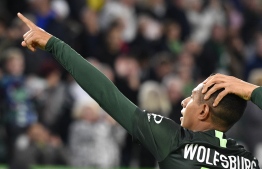 Wolfsburg's Brazilian forward Joao Victor (C) celebrates his goal, that was later disallowed, during the German First division Bundesliga football match between VfL Wolfsburg and FC Augsburg, on October 27, 2019 in Wolfsburg. - The goal was later disallowed. (Photo by John MACDOUGALL / AFP) / DFL REGULATIONS PROHIBIT ANY USE OF PHOTOGRAPHS AS IMAGE SEQUENCES AND/OR QUASI-VIDEO