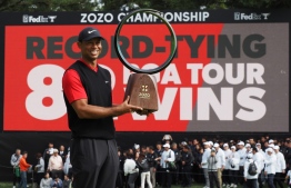 Tiger Woods of the US holds a victory trophy during the awarding ceremony of the PGA ZOZO Championship golf tournament at the Narashino Country Club in Inzai, Chiba prefecture on October 28, 2019. (Photo by TOSHIFUMI KITAMURA / AFP)