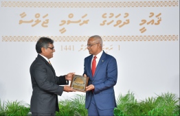 President Solih presents National Award of Recognition to Ibrahim Solih, for his contributions to promoting arts and crafts. PHOTO: HUSSAIN WAHEED / MIHAARU