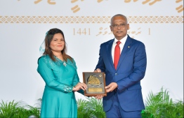 President Solih presents National Award of Recognition to Zeenaz Hussain, for her contributions in the field of tourism and training tourism-sector staff. PHOTO: HUSSAIN WAHEED / MIHAARU