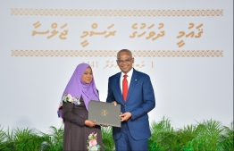President Solih presents National Award of Recognition to Rahma Easa, for her contributions in the area of human rights and social protection. PHOTO: HUSSAIN WAHEED / MIHAARU