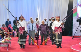 Ahmed Adam and Abdulla Sodiq are escorted to the stage, to be conferred the Order of the Distinguished Rule of Izzuddin. PHOTO: HUSSAIN WAHEED / MIHAARU