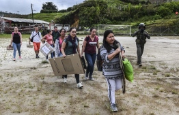 Electoral authorities are escorted by soldiers as they transport voting material in Argelia, Antioquia department, Colombia on October 25, 2019, ahead of Sunday's regional elections. (Photo by JOAQUIN SARMIENTO / AFP)