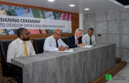 HDC's Managing Director Suhail Ahmed (L-2) and BML's CEO Timothy Sawyer (R-2) sign the agreement awarding a land plot in Hulhumale' for the development of BML's new office building. PHOTO/HDC