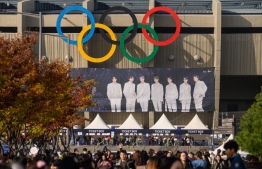 In a photo taken on October 29, 2019, fans of South Korea's BTS K-pop group arrive for the final concert of their world tour at the Olympic stadium in Seoul. - The BTS world tour which ran from August last year and ended on October 29 drew a total audience of more than two million at 62 shows in 23 cities, according to Big Hit Entertainment. BTS is worth 4.1 trillion won to the South Korean economy every year -- equivalent to the contribution of 26 mid-sized companies -- the Hyundai Research Institute said in a report published last December. (Photo by Ed JONES / AFP) / To go with  SKorea-entertainment-music-BTS, FOCUS by Hwang Sunghee