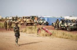 (FILES) In this file photo taken on October 14, 2018 Malian soldiers secure the airport of Mopti ahead of the arrival of Malian Prime Minister Soumeylou Boubeye Maiga. - Fifty-three soldiers were killed on November 1, 2019, in a "terrorist attack" on a Mali military post in the northeast of the country.
The assault is one of the deadliest strikes against Mali's military in recent Islamist militant violence. (Photo by MICHELE CATTANI / AFP)