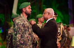 President Ibrahim Mohamed Solih pins the silver medal on Sergeant Ismail Rihuhan of the Maldives National Defence Force. PHOTO: NISHAN ALI / MIHAARU