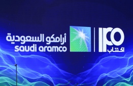 A picture taken on November 3, 2019 shows a sign of Saudi Aramco's initial public offering (IPO) during a press conference by the state company in the eastern Saudi Arabian region of Dhahran. - Saudi Aramco confirmed it planned to list on the Riyadh stock exchange, describing it as a "significant milestone" in the history of the energy giant. -- Photo:  AFP