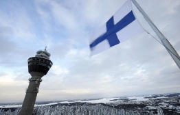 A national Finish flag flies close to Puijo hill's observation tower on March 8, 2010 as training and qualification round of the Ski jumping world cup were cancelled due to bad wind conditions in Kuopio.    AFP PHOTO/ LEHTIKUVA/ MARTTI KAINULAINEN     ***  ***