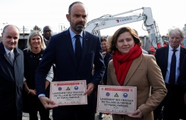 French Prime Minister Edouard Philippe and French Sports Minister Roxana Maracineanu pose during a ceremony marking the start of the constructions of the future Olympic and paralympic games village for Paris 2024 Olympic games, on November 4, 2019 in Saint-Ouen. (Photo by GONZALO FUENTES / POOL / AFP)