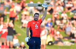 England's Dawid Malan celebrates 100 runs during the Twenty20 cricket match between New Zealand and England at McLean Park in Napier on November 8, 2019. (Photo by Marty MELVILLE / AFP)