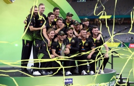 Australia players celebrate their victory in the Twenty20 cricket series against Pakistan at Optus Stadium in Perth on November 8, 2019. (Photo by Tony ASHBY / AFP) / 