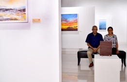 President Ibrahim Mohamed Solih and First Lady Fazna Ahmed observing a painting by Ahmed Amir at his art exhibit 'Impermanence'. PHOTO: PRESIDENT'S OFFICE