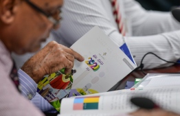 A member of the budget committee skimming through the 2020's state budget booklet. Ministry of Finance decided to review this year's budget due to the decreased revenue collected by the state. PHOTO: NISHAN ALI/ MIHAARU