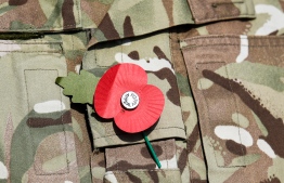 This picture taken on November 5, 2019 during the the International Maritime Exercise (IMX) in the Gulf waters off Bahrain shows a close-up of a remembrance poppy worn by a British serviceman during the exercises. - IMX is a joint military exercise involving assets and personnel from more than 50 partner nations and seven international organisations. The US has pushed for the creation of a US-led operation dubbed the International Maritime Security Construct to safeguard trade and the flow of oil through the Strait of Hormuz. It has so far been joined by Australia, Britain and the United Arab Emirates, as well as Bahrain, the Gulf island state which is home to the US Fifth Fleet. (Photo by KARIM SAHIB / AFP)