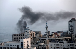 Smoke rises after an Israeli airstriked in Gaza City on November 13, 2019. - Israel's military killed a commander from Palestinian militant group Islamic Jihad in a strike on his home in the Gaza Strip, triggering exchanges of fire in a violent escalation that left another nine Gazans dead. (Photo by MAHMUD HAMS / AFP)