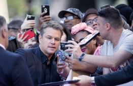 US actor Matt Damon poses for pictures with fans as he attends the "Ford v Ferrari" premiere at the Roy Thompson Hall during the 2019 Toronto International Film Festival Day 5, September 9, 2019, in Toronto, Ontario. (Photo by VALERIE MACON / AFP)