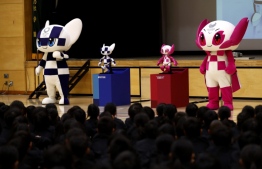 Tokyo 2020 Olympic and Paralympic Games' mascots and robot-type mascots Miraitowa (L) and Someity (R) attend a ceremony at Hoyonomori elementary school in Tokyo on November 18, 2019. Tokyo 2020 Summer Games' mascot robots visited an elementary school, drawing cheers and laughters from children as they gave them quizzes and responded to verbal instructions.
Behrouz MEHRI / AFP