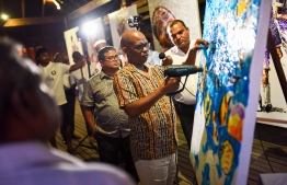 Mbongeni Buthelezi demonstrating his plastic painting method following the unveiling of the exhibition. PHOTO: COCO PALM BODU HITHI