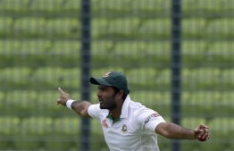 (FILES) In this file photo taken on May 6, 2015 Bangladeshi cricketer Shahadat Hossain reacts after taking a catch to dismiss Pakistan batsman Sami Aslam during the first day of the second cricket Test match between Bangladesh and Pakistan at The Sher-e-Bangla National Cricket Stadium in Dhaka. - The Bangladesh Cricket Board on November 19 banned former national team fast bowler Shahadat Hossain for five years after he assaulted a teammate in a match. The temperamental Shahadat was reported by umpires after he was seen to slap and kick a teammate during a National Cricket League match on November 17. (Photo by Munir UZ ZAMAN / AFP)