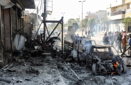 This picture taken on November 23, 2019 shows the aftermath of a car bomb explosion at the industrial zone in the northern Syrian town of Tal Abyad, on the border with Turkey. - Several people were killed, including civilians, over a dozen injured by the blast in the Turkish-controlled northern Syrian town. Turkey and its Syrian proxies control several pockets of territory on the Syrian side of the border as a result of successive incursions in 2016-17, 2018 and 2019. (Photo by Zein Al RIFAI / AFP)