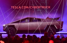 People take pictures of the newly unveiled all-electric battery-powered Tesla's Cybertruck with shattered windows after a failed resistance test, at Tesla Design Center in Hawthorne, California on November 21, 2019.
FREDERIC J. BROWN / AFP