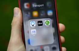 Transport apps including Uber and Zipcar are seen on a smartphone in London on November 25, 2019. - London's transport authority today refused to renew an operating licence for ride-hailing giant Uber because of safety and security concerns. (Photo by Daniel LEAL-OLIVAS / AFP)