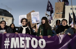 People take part in a protest to condemn violence against women, on November 24, 2019, in Brussels. (Photo by Kenzo TRIBOUILLARD / AFP)