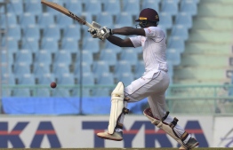 West Indies' Shamarh Brooks plays a shot during the second day of the only cricket Test match between Afghanistan and West Indies at the Ekana Cricket Stadium in Lucknow on November 28, 2019. - Overnight batsman Shamarh Brooks hit his second successive Test half-century to give West Indies the lead on day two of the one-off Test against Afghanistan on November 28. (Photo by Rohit UMRAO / AFP) / 