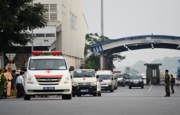 Vehicles carrying some of the remains of the 39 UK truck victims leave Noi Bai airport in Hanoi on November 27, 2019 - The first remains of the 39 people found dead in a truck in Britain last month arrived in Vietnam early, an airport security source said. (Photo by Nhac NGUYEN / AFP)